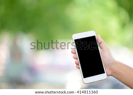 Man hand holding smartphone  on blurred background