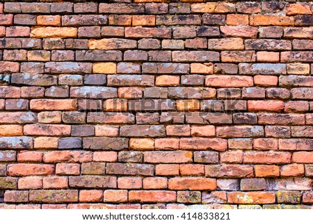 old wall of red and orange bricks for texture, or background
