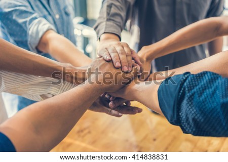 business people making pile of hands , soft focus, vintage tone Royalty-Free Stock Photo #414838831