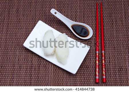 Nigiri with halibut on a placemat bamboo seen from above