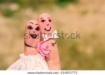 Funny men painted on the fingers. Newlyweds. Wedding