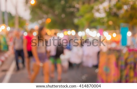Abstract  blur image of night market on street with bokeh , for background usage .
