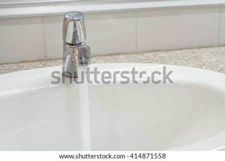 Bathroom interior with white sink and faucet