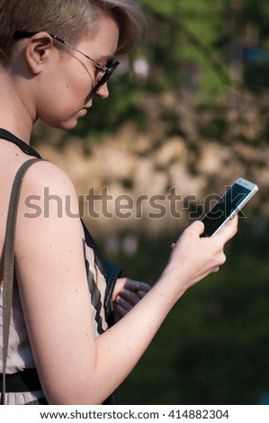 girl holding a phone in his hand