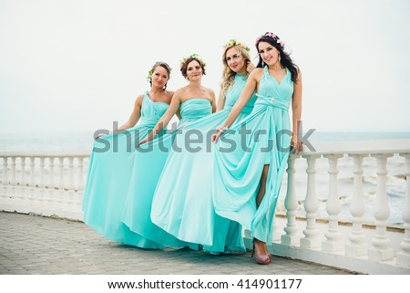 Bridesmaids on the seaside in blue dresses Royalty-Free Stock Photo #414901177