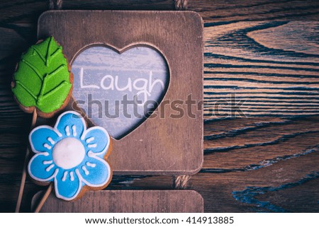 Blue flower and green leaves. Laugh and eat the cookies.