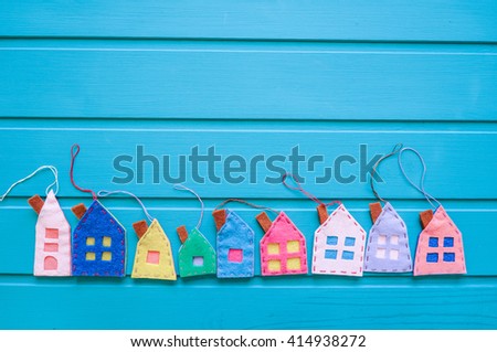 Spring background with houses over blue wooden background