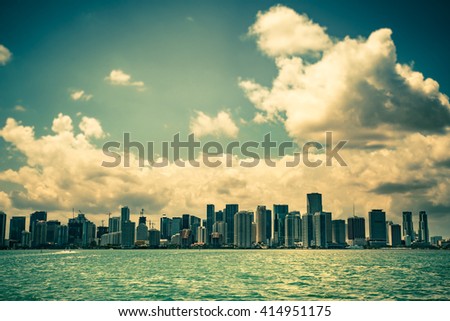 Miami Florida skyline under dramatic clouds in sky.  toned image