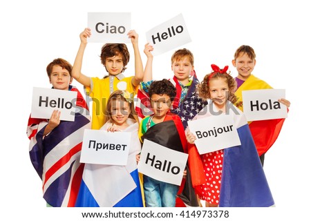 Kids holding greeting signs in different languages Royalty-Free Stock Photo #414973378