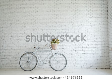 Retro bicycle on roadside with vintage brick wall background, Royalty-Free Stock Photo #414976111