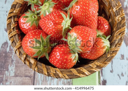 Ripe red strawberries in bamboo bowl 