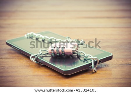 vintage image of pink padlock and chain on mobile,smart phone,tablet,cell phone ,still life,safety privacy data and business data in mobile concept
