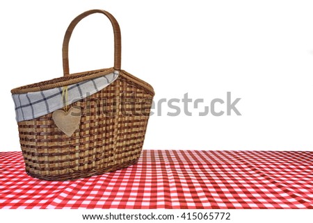 Picnic Basket On The Red Checkered Tablecloth Isolated On White Background