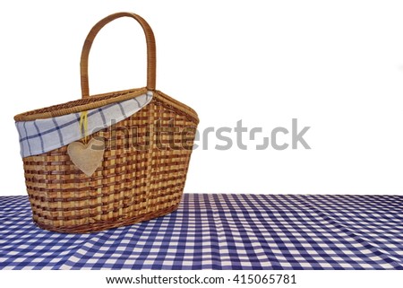 Picnic Basket On The Blue Checkered Tablecloth Isolated On White Background