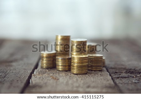 Gold money coins pile on wooden table
