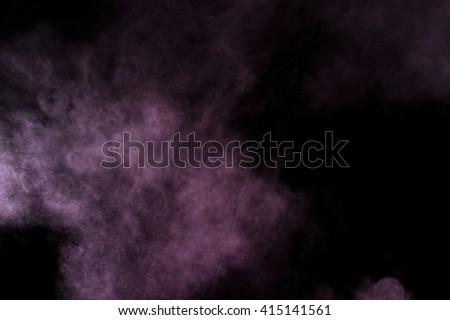Purple powder explosion on black background. Colored powder cloud. Colorful dust explode. Paint Holi.