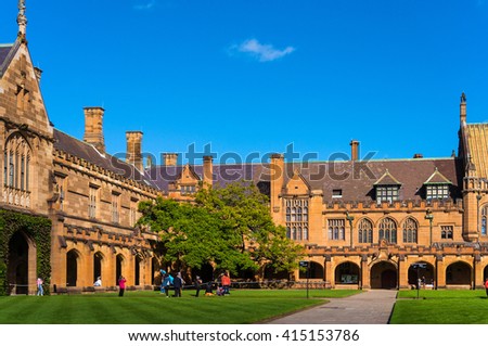 Sydney Uni inner yard with students in the distance enjoying break. University of Sydney courtyard against deep blue sky with white clouds, daytime photo