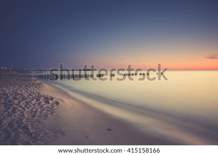  Landscape polish sea shore with breakwaters. Sunrise over the sea.