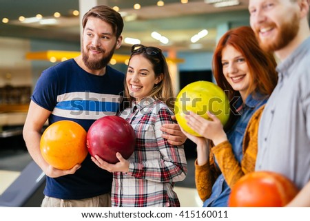 Friends having fun while bowling and spending time together