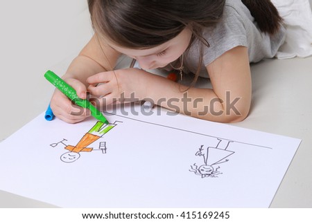 Girl in bright clothing draws a picture of the family. Light room. father's alcoholism