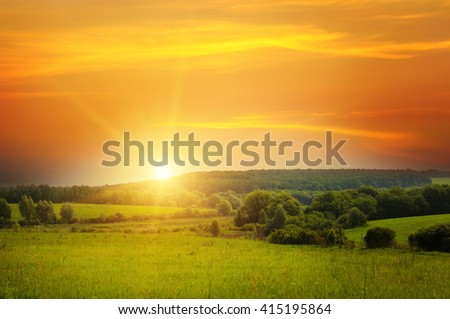 field, sunrise and blue sky Royalty-Free Stock Photo #415195864