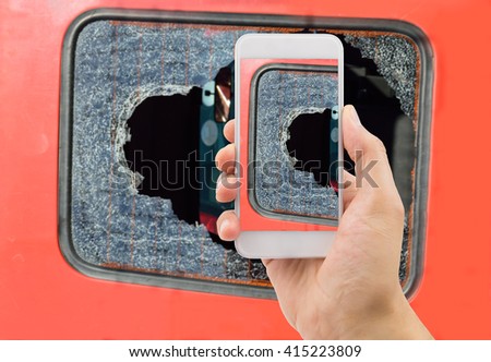 Man photographing the broken glass of your industrial van 