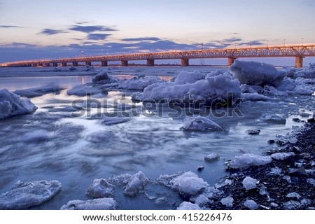 Spring ice drift on the Amur river. Area of the Amur bridge. Trans Siberian railway. Khabarovsk, far East, Russia. Royalty-Free Stock Photo #415226476