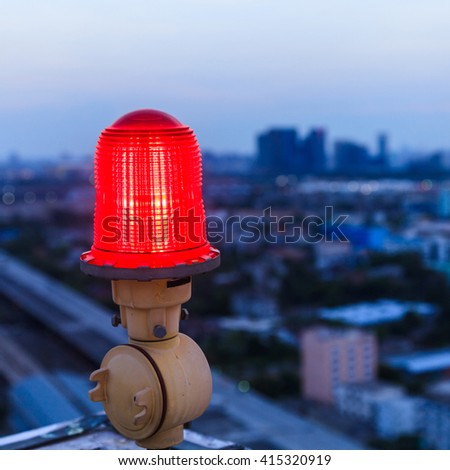 Close up of an aircraft warning light on top of a highrise of building
