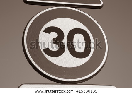 Thirty Speed Sign against Sky Background in Black and White Sepia Tone