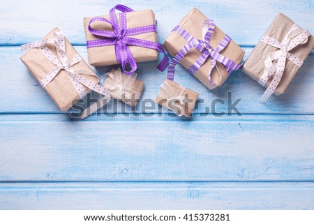 Many  festive gift boxes with presents on blue wooden background. Selective focus. Place for text.
