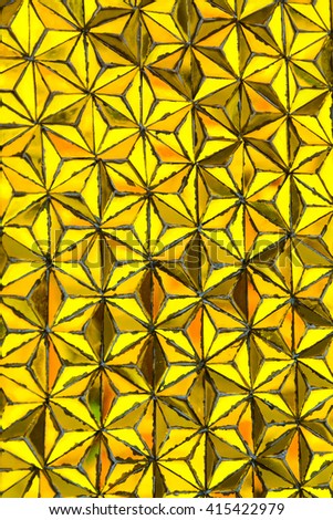 Gold texture with mosaic pattern in Wat Traimit. Bangkok, Thailand. Selective focus