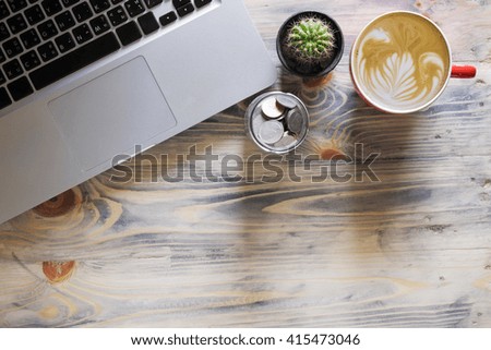Office wood table with computer and coffee cup. View from above with copy space