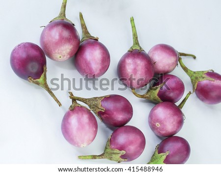 Thai purple eggplants or purple small brinjal isolate on a  background.