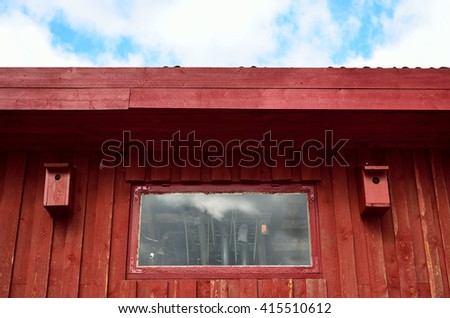 red barn wall with two bird houses