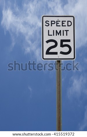 25 MPH SPEED LIMIT SIGH WITH BRIGHT BLUE SKY BACKGROUND