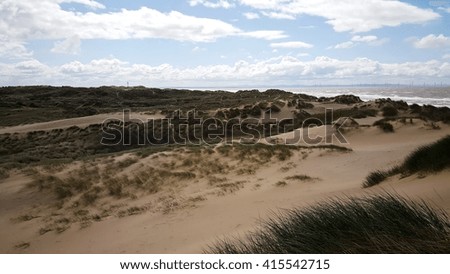 sunny beach with sand dunes and blue sky