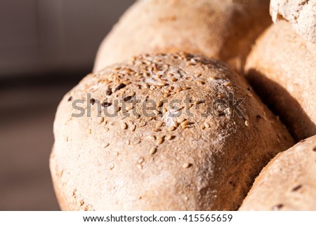 Organic home made bread with flax seeds and rural background