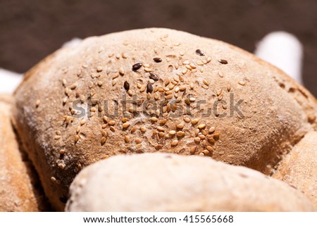 Organic home made bread with flax seeds and rural background