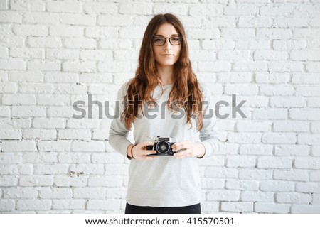 woman photographer holding a film camera in hands