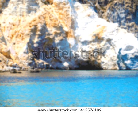 Defocused generic background of a white cliff with blue sea. Intentionally blurred post production for bokeh effect.