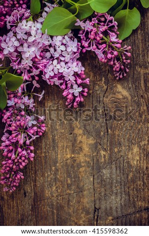 Beautiful spring flowers lilac on a wooden vintage board with place for text. Syringa vulgaris. Happy Mother's Day greetings card. Top view. Copy space.