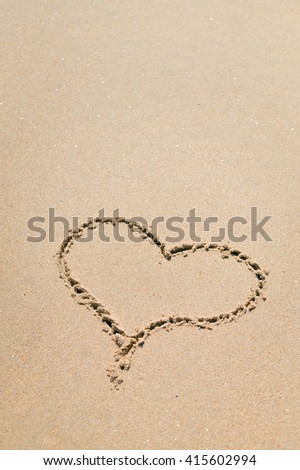 Love Heart drawn on sandy atlantic coast background