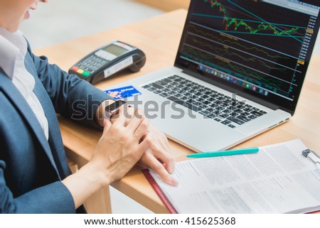 woman investment consultant analyzing company annual financial report balance sheet statement working with documents graphs. Stock market, office, tax, education concept. Hands with watch Royalty-Free Stock Photo #415625368