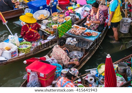 Colorful trader's boats in a floating market in Thailand. Floating markets are one of the main cultural tourist destinations in Asia. Royalty-Free Stock Photo #415641943