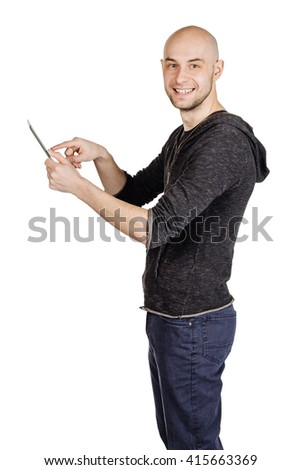 portrait young bald man using tablet computer. emotions, facial expressions, feelings, body language, signs. image on a white studio background.