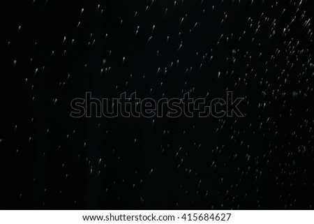 Rain on a black background. Abstract background