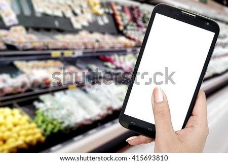 Hand holding  blank screen mobile with blur supermarket background