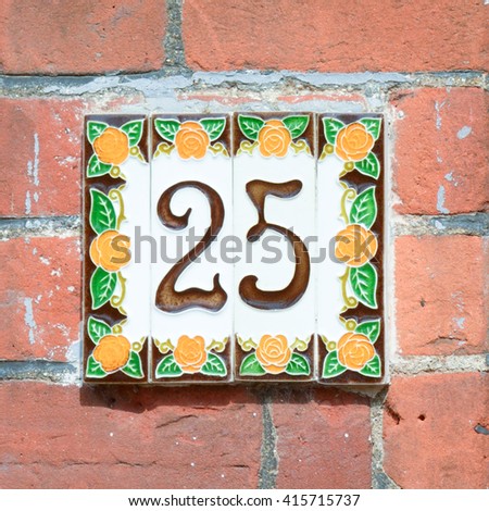House Number 25 sign on wall