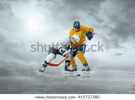 Ice hockey players in action outdoor around mountains