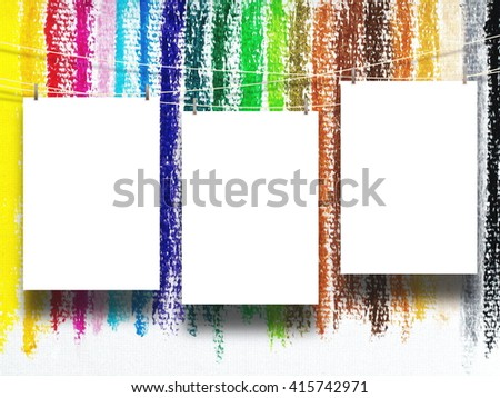 Close-up of three blank frames hanged by pegs against multicolored chalk drawing background